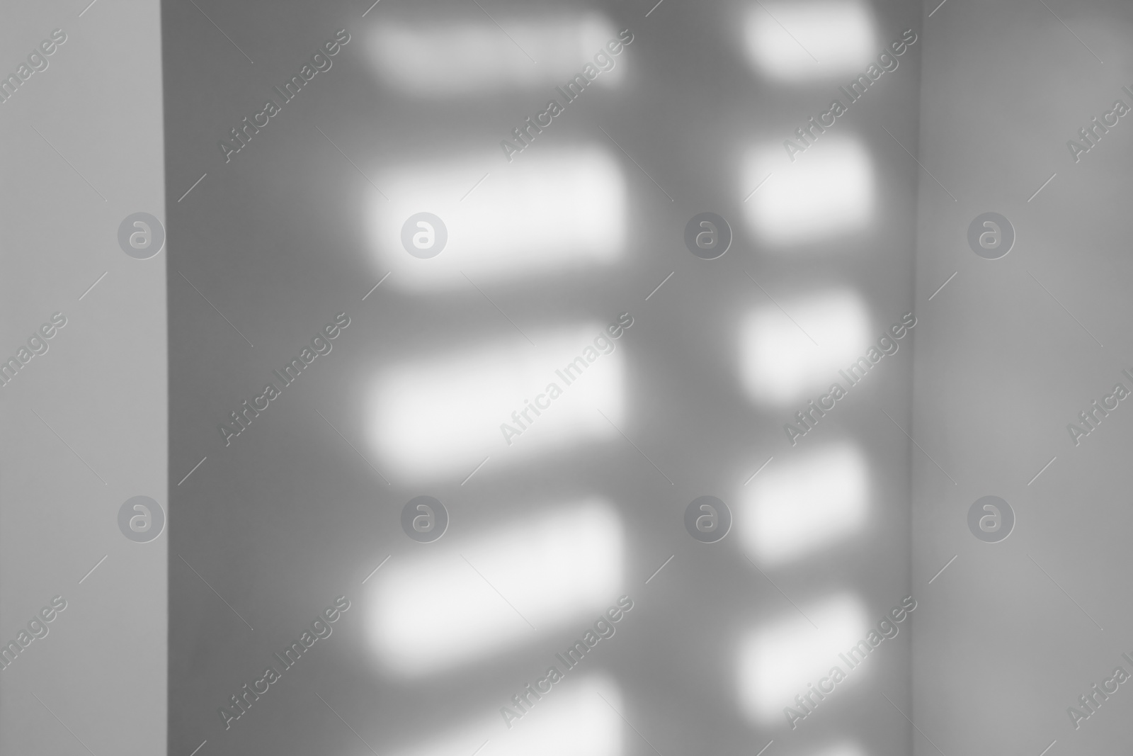 Image of Light and shadows falling on white wall