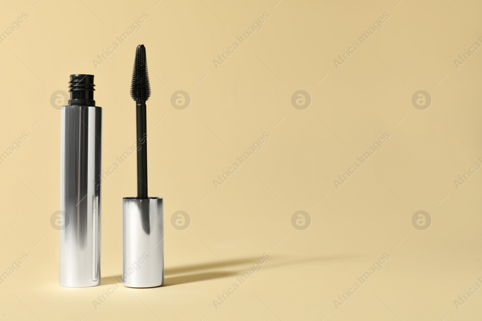 Photo of Mascara on beige background, space for text