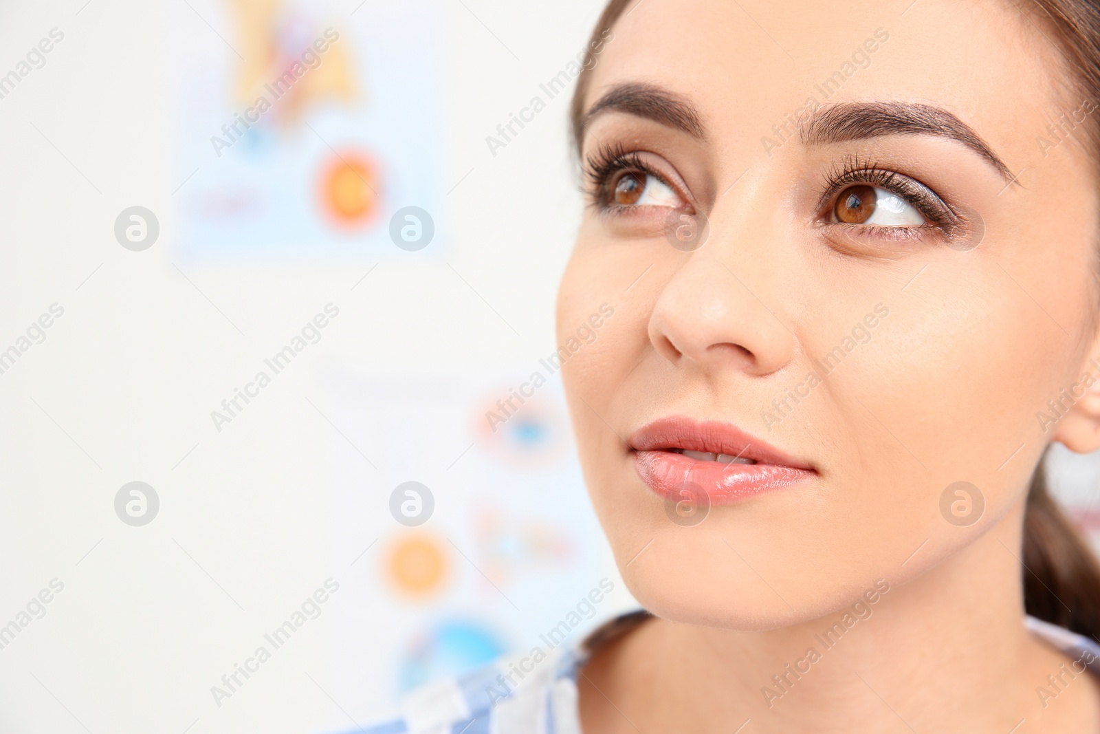 Photo of Young woman visiting ophthalmologist