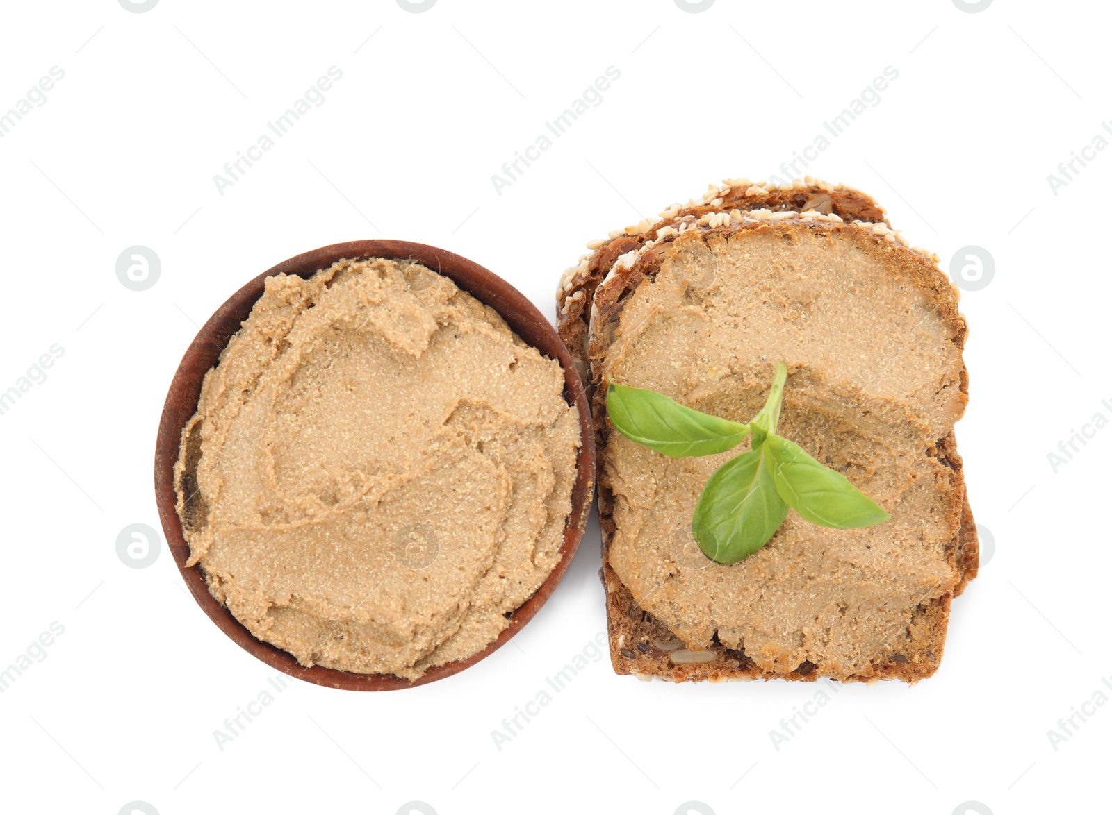 Photo of Fresh bread with delicious meat pate and basil on white background, top view
