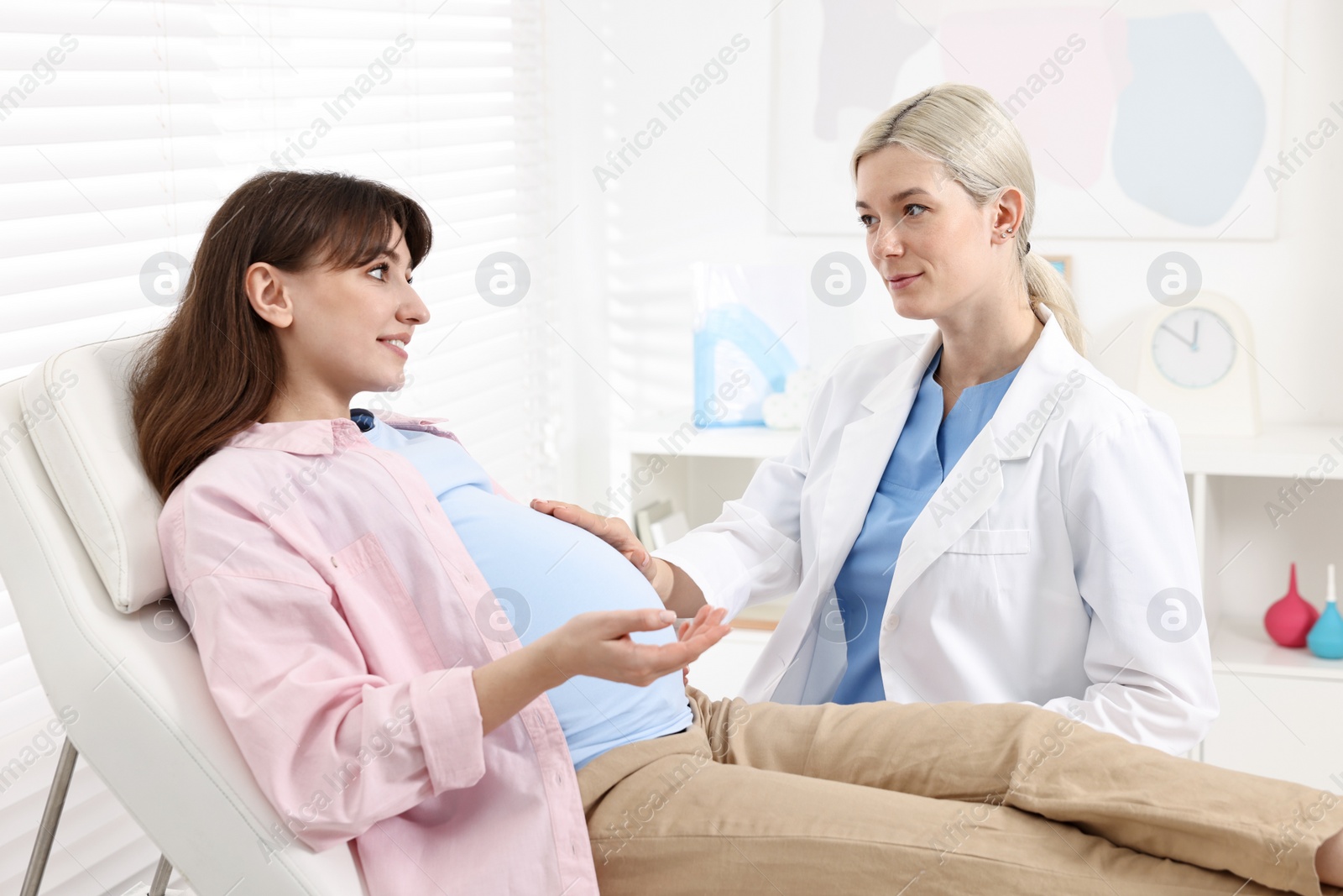 Photo of Happy pregnant woman having doctor appointment in hospital