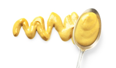 Photo of Delicious mustard and spoon on white background, top view. Spicy sauce