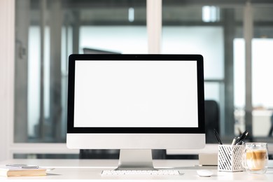 Photo of Modern computer on white desk in office. Mockup for design