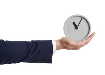 Young businessman holding clock on white background. Time management