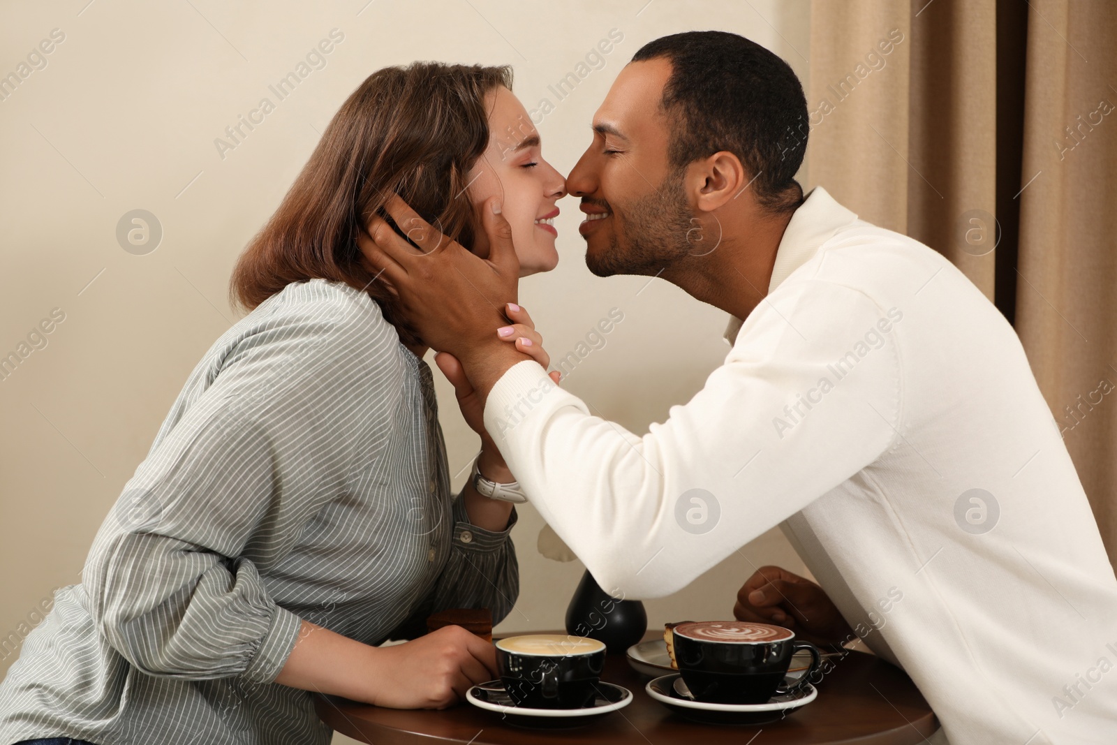 Photo of Romantic date. Happy couple spending time together in cafe