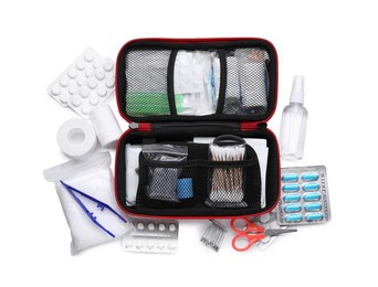 Photo of First aid kit, scissors, pins, cotton buds, pills, plastic forceps, hand sanitizer, medical plaster and elastic bandage isolated on white, top view