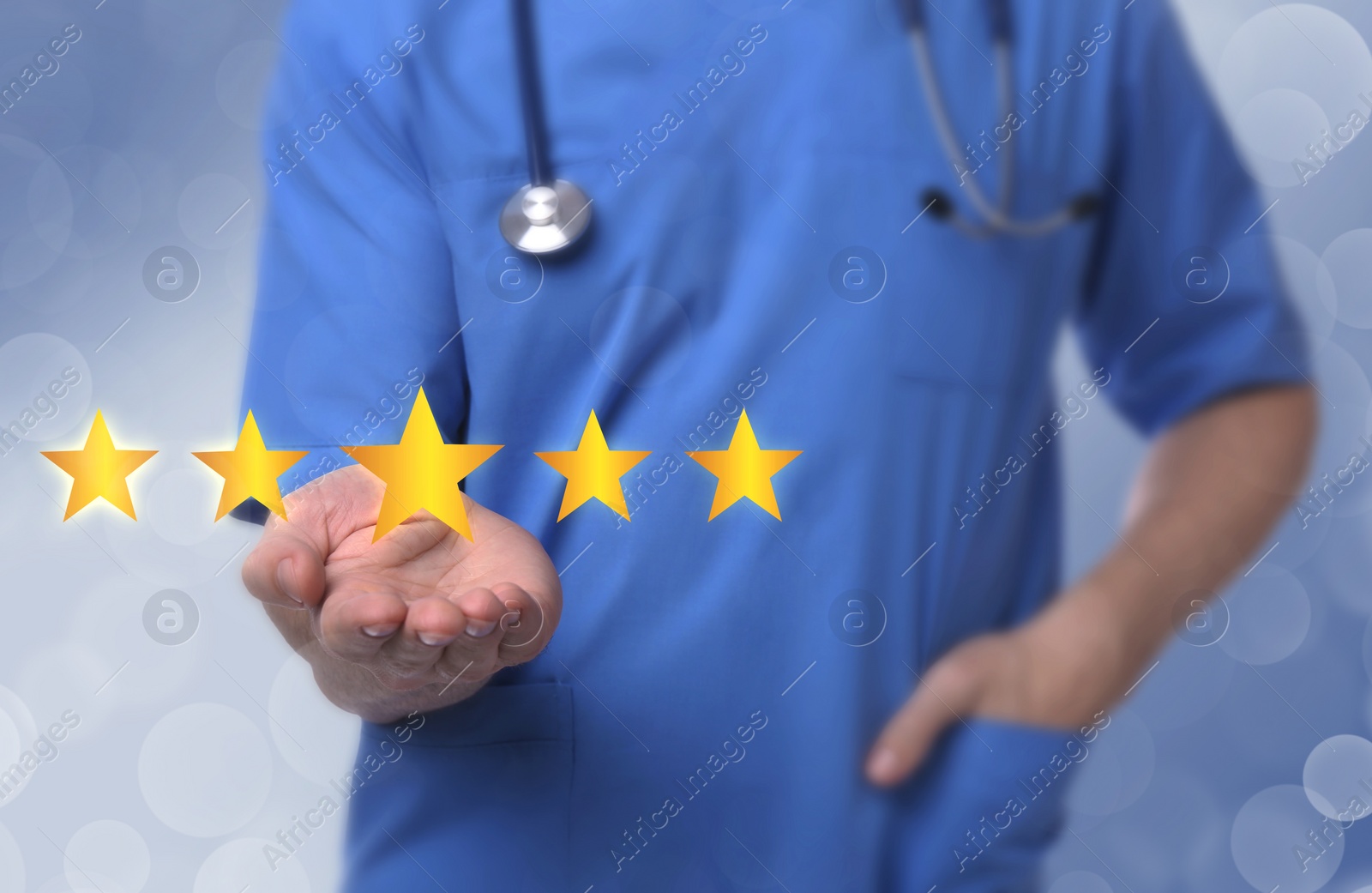 Image of Quality evaluation. Doctor showing virtual golden stars on light blue background, closeup