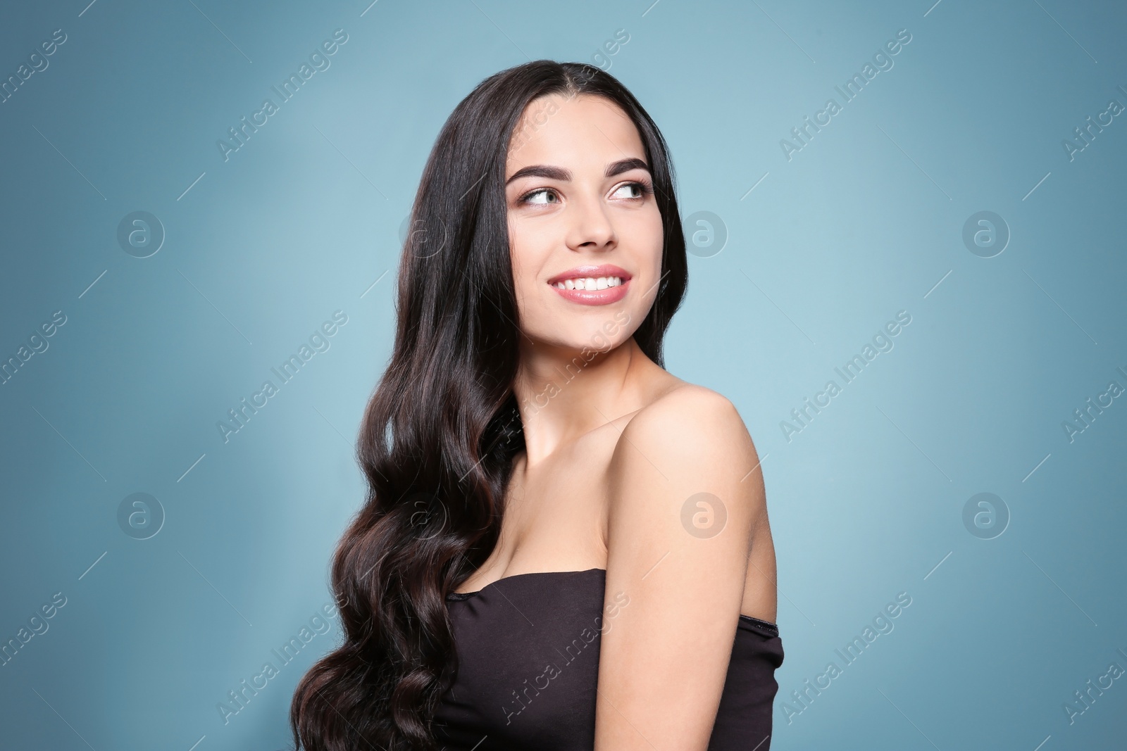 Photo of Portrait of beautiful model with gorgeous curly hair on color background