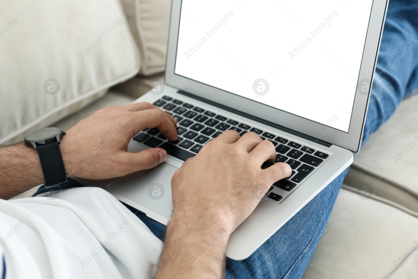 Photo of Man working on modern laptop at home, closeup