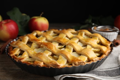 Photo of Delicious traditional apple pie on wooden table, closeup