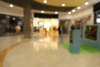 Photo of Blurred view of modern shopping mall interior. Bokeh effect