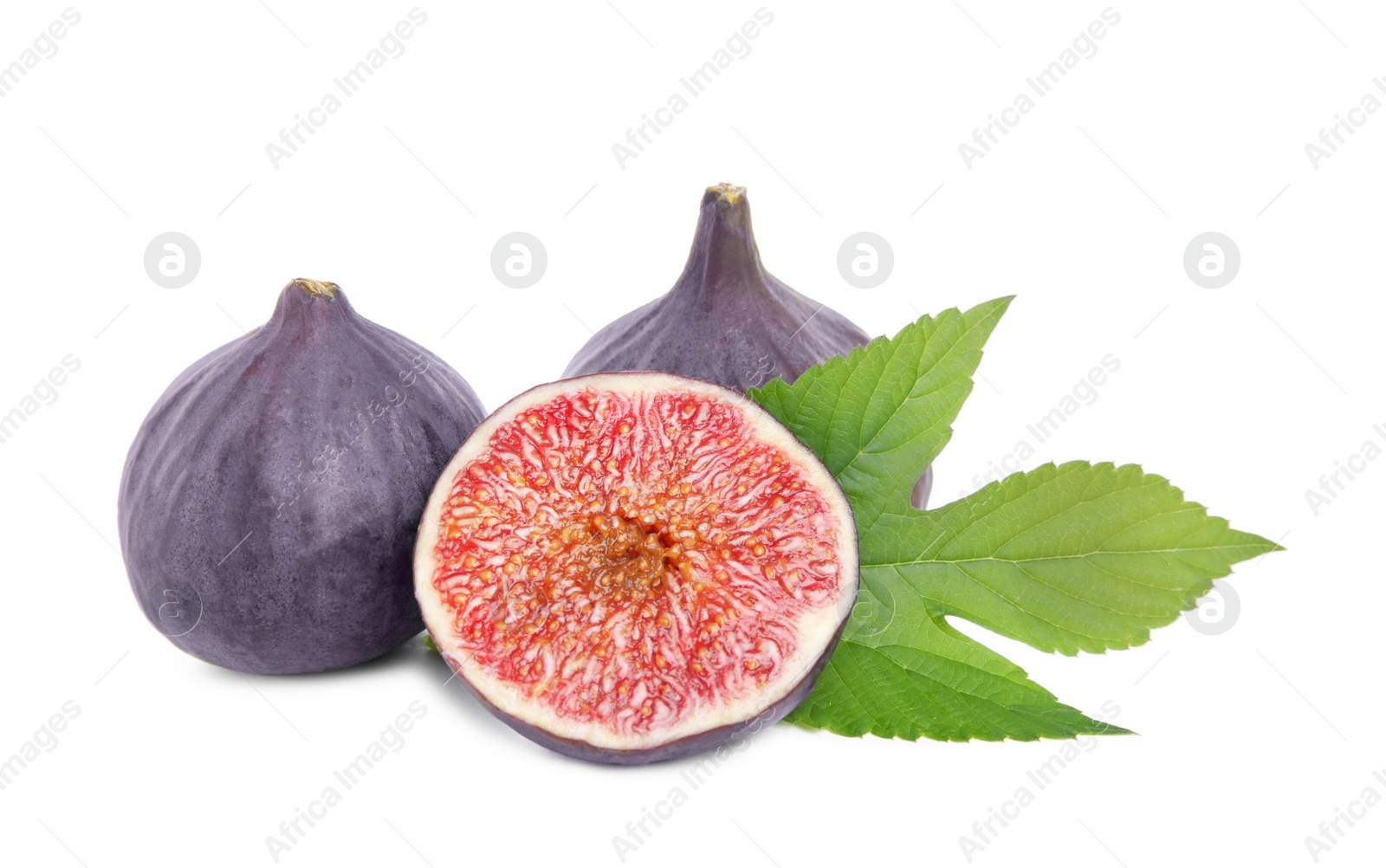 Photo of Whole and cut fresh ripe figs with green leaf isolated on white