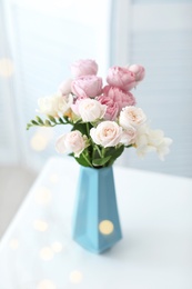 Vase with beautiful flowers on table indoors