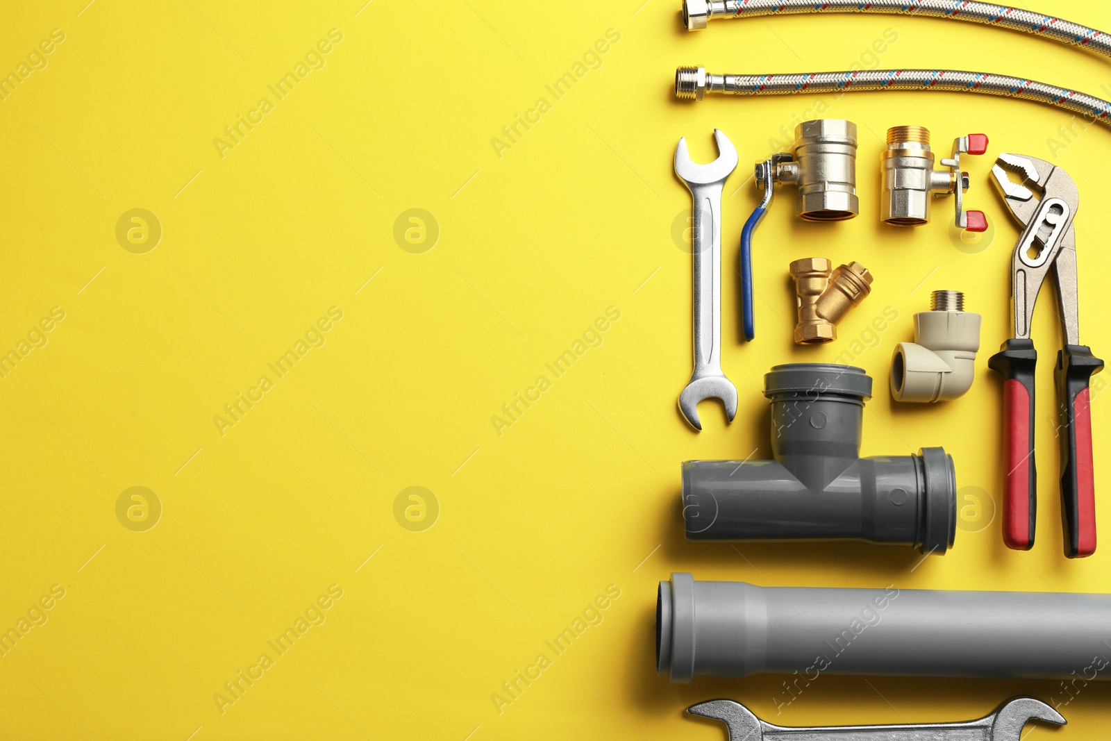 Photo of Flat lay composition with plumber's tools and space for text on color background