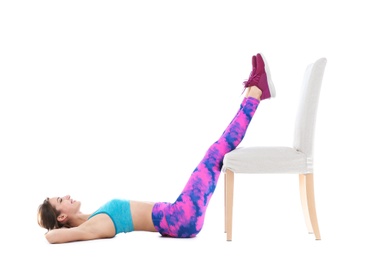 Photo of Young woman exercising with chair on white background. Home fitness