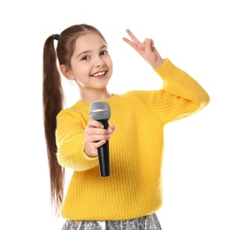 Little girl singing into microphone on white background