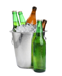 Photo of Metal bucket with bottles of beer and ice cubes isolated on white