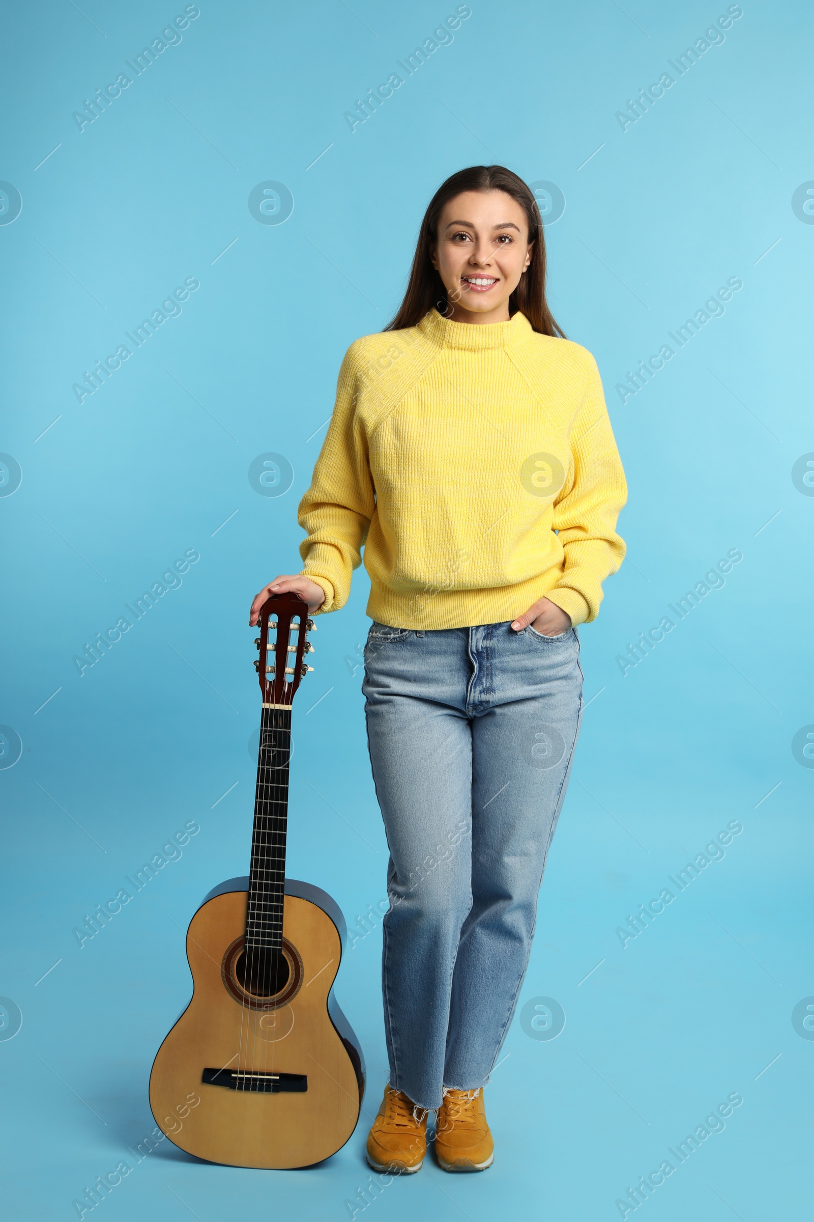 Photo of Music teacher with guitar on turquoise background