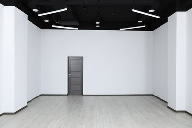 Photo of Empty office with dark wooden door. Interior design