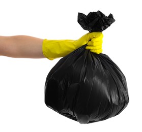 Photo of Woman holding plastic bag full of garbage on white background, closeup