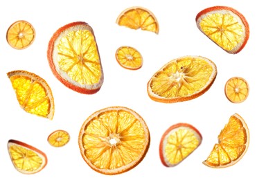Image of Many dry orange slices falling on white background