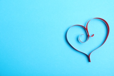 Heart made of paper strips on color background, top view. Space for text