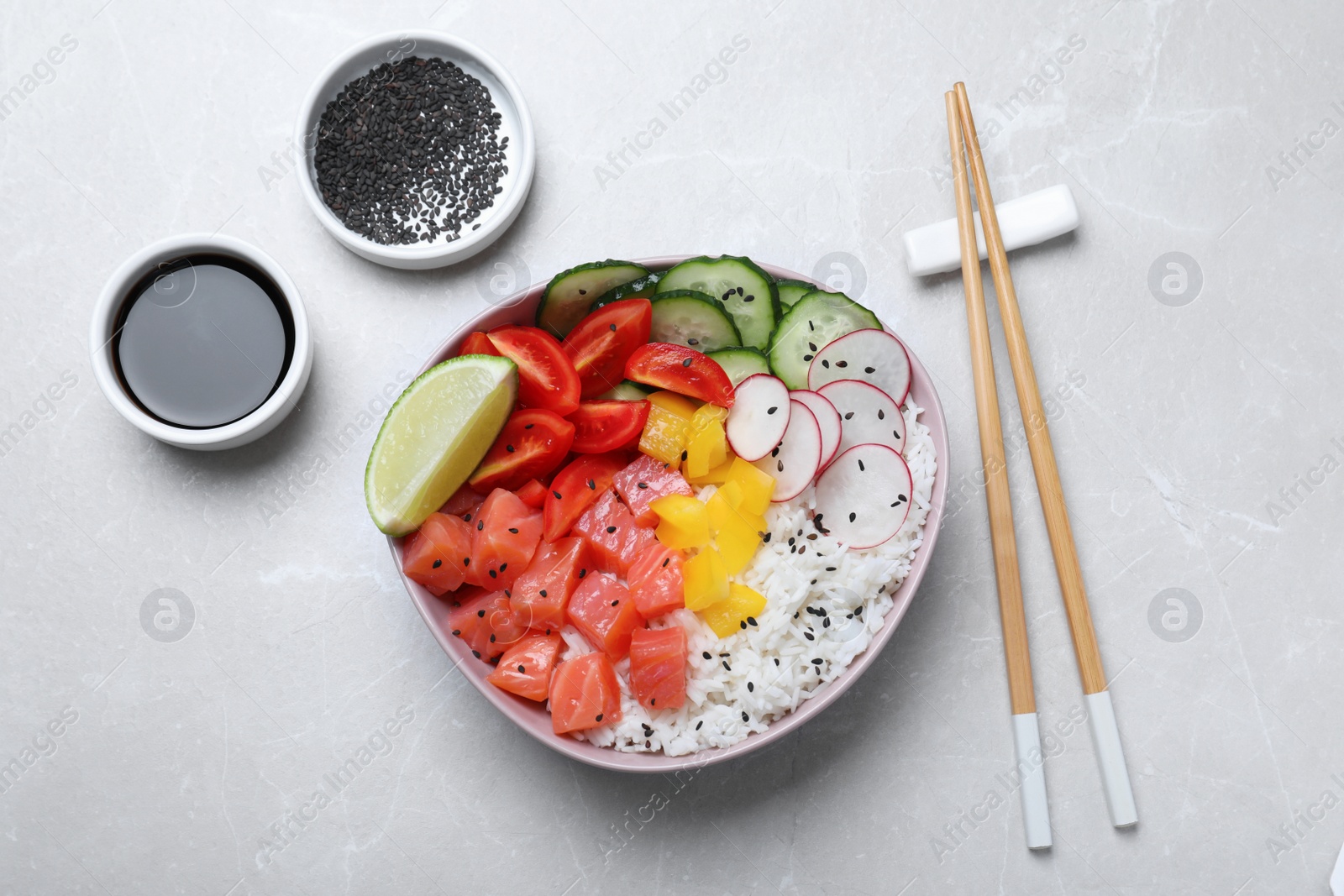 Photo of Delicious poke bowl with salmon, rice and vegetables served on light grey table, flat lay