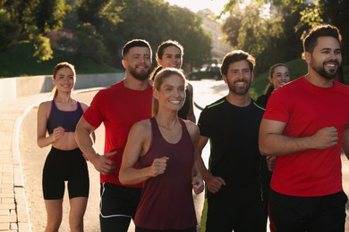 Group of people running outdoors on sunny day