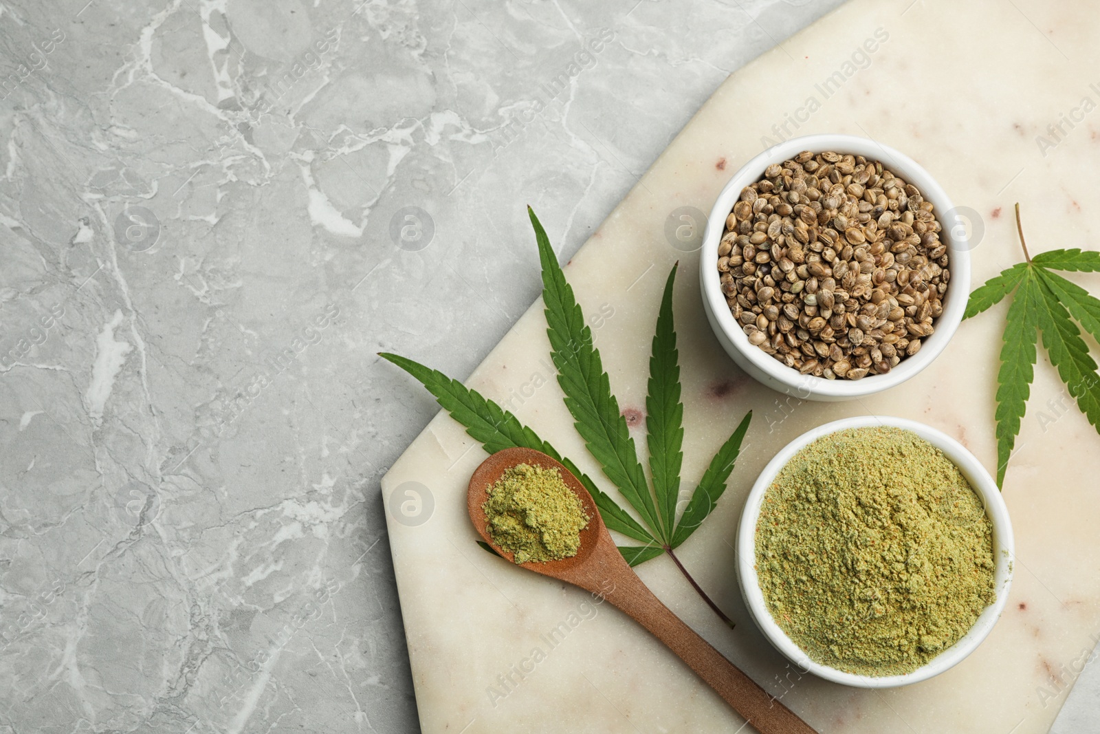 Photo of Flat lay composition with hemp protein powder and seeds on marble table. Space for text