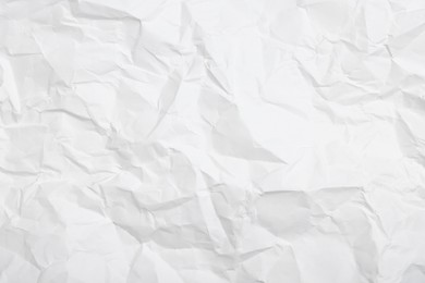 Photo of Sheet of white crumpled paper as background, closeup