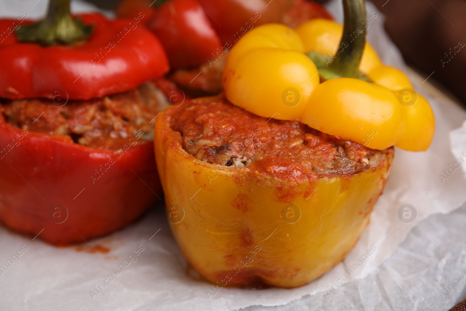 Photo of Delicious stuffed bell peppers served on table, closeup