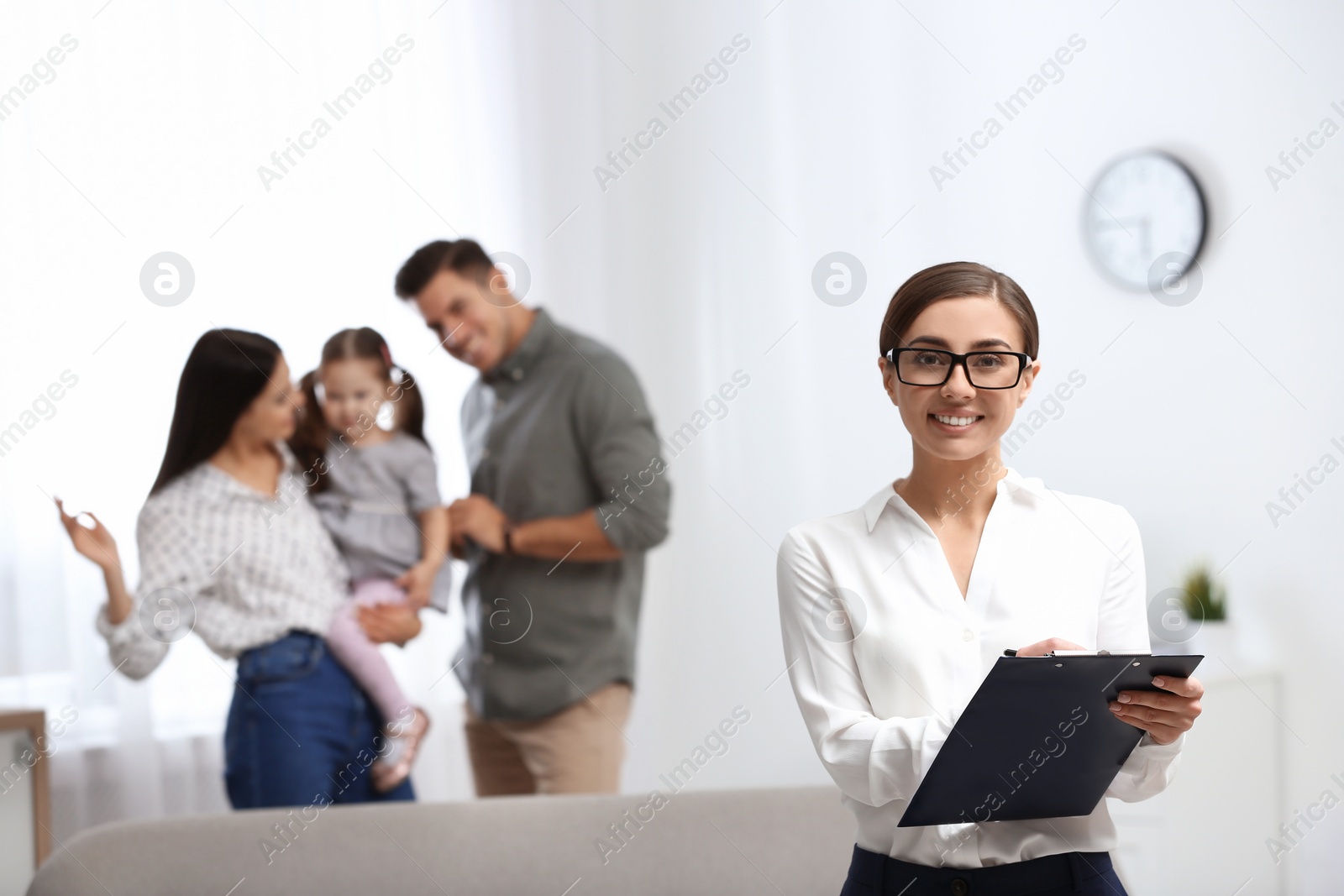 Photo of Professional psychologist and happy family in office