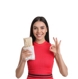 Happy young woman with delicious shawarma on white background