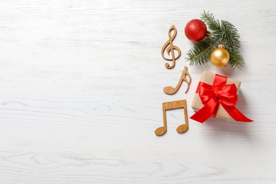 Flat lay composition with decorations and  notes on wooden background. Christmas music concept