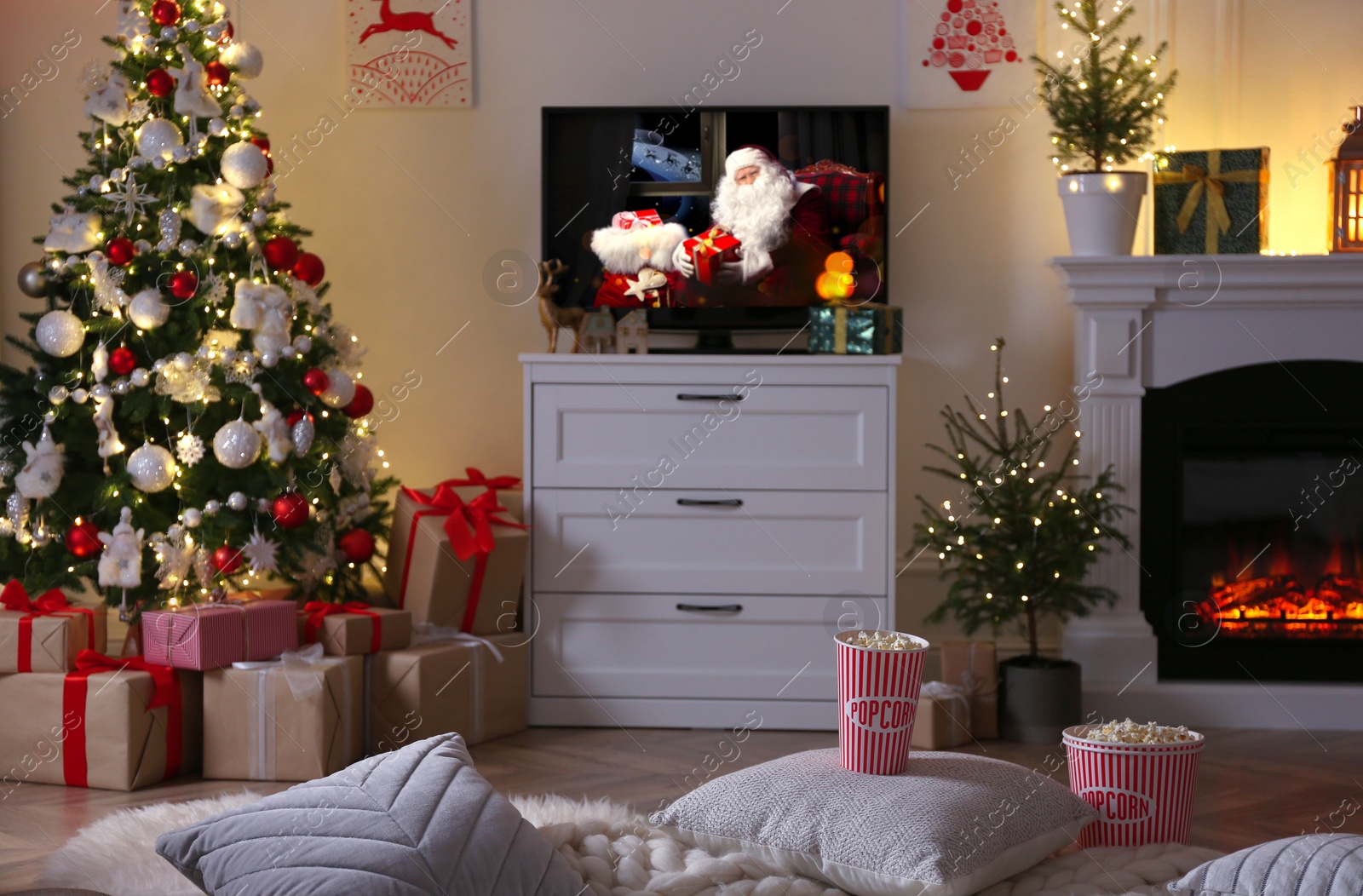 Image of Stylish living room interior with TV set, Christmas tree and fireplace