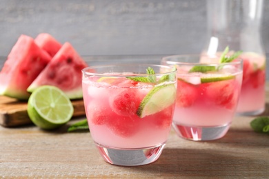 Photo of Tasty refreshing watermelon drink on wooden table