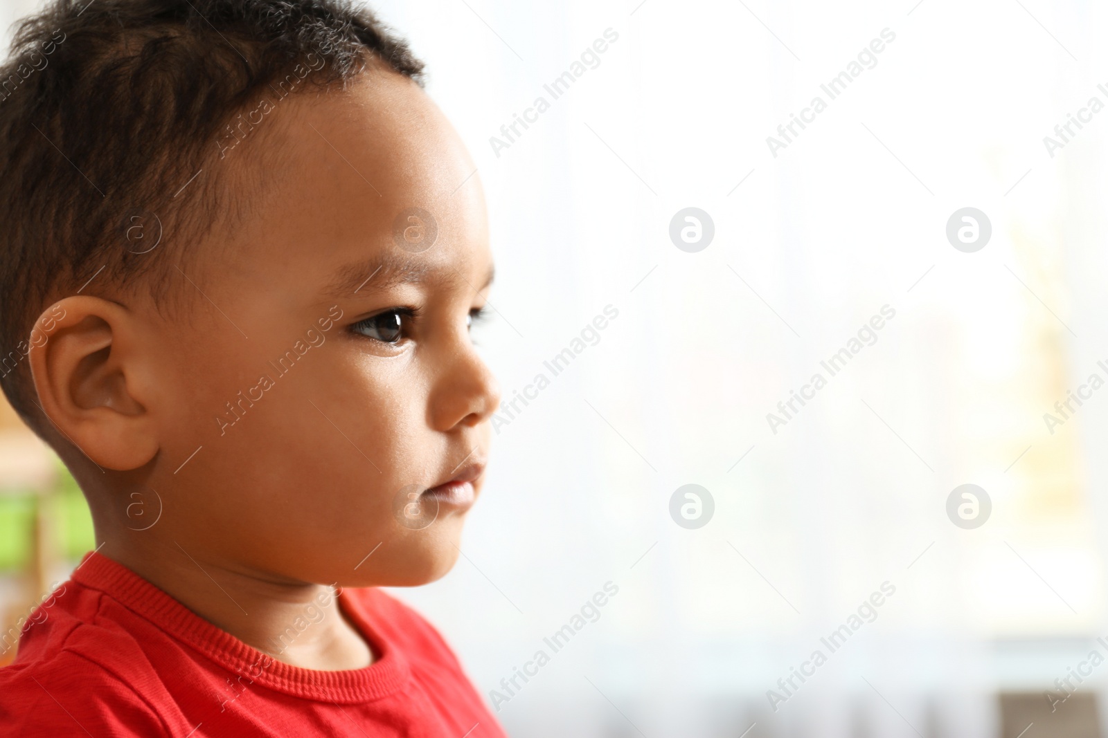Photo of Cute little African-American child in kindergarten, space for text