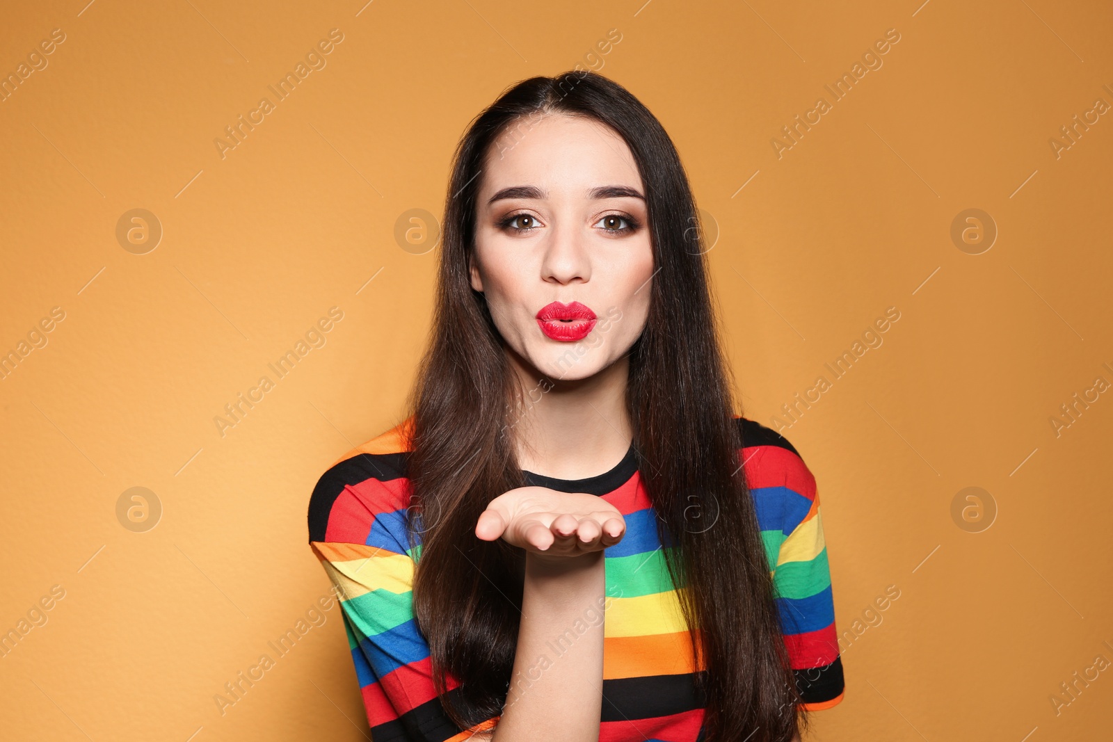 Photo of Portrait of beautiful young woman on colorful background