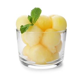 Glass with melon balls on white background