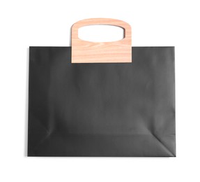 Photo of One black paper shopping bag isolated on white, top view