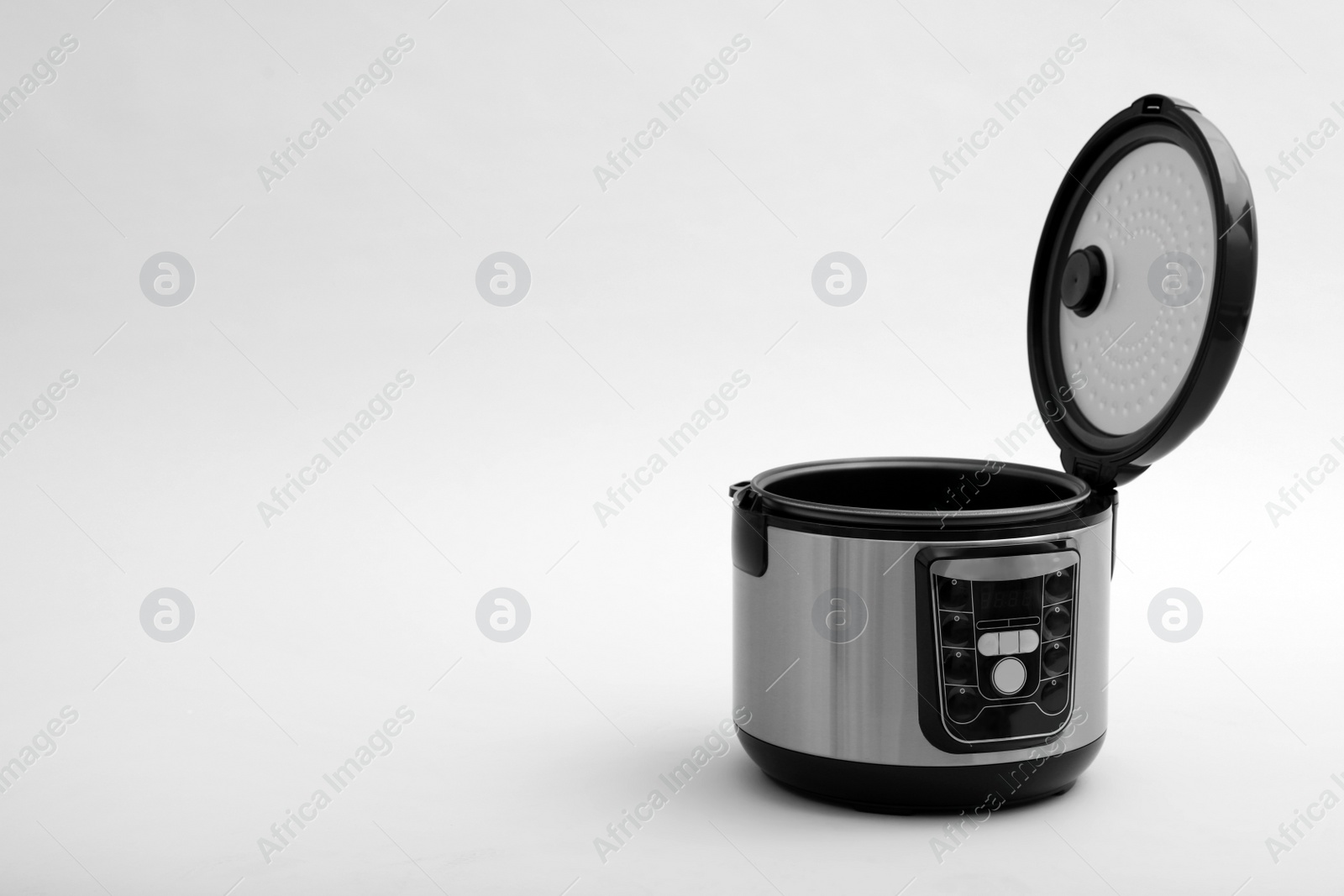 Photo of Modern electric multi cooker on light background. Space for text