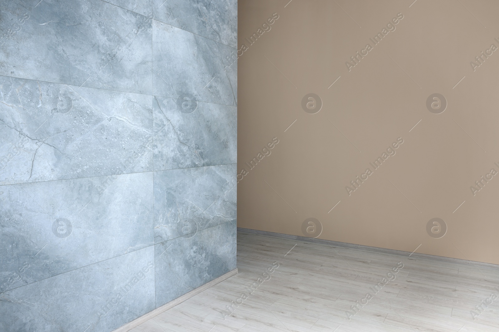 Photo of New empty room with clean stone wall