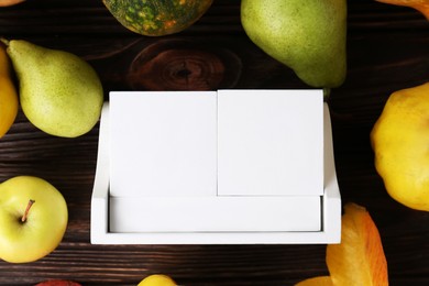 Thanksgiving day, holiday celebrated every fourth Thursday in November. Block calendar, fruits, vegetables and autumn leaves on wooden table, flat lay