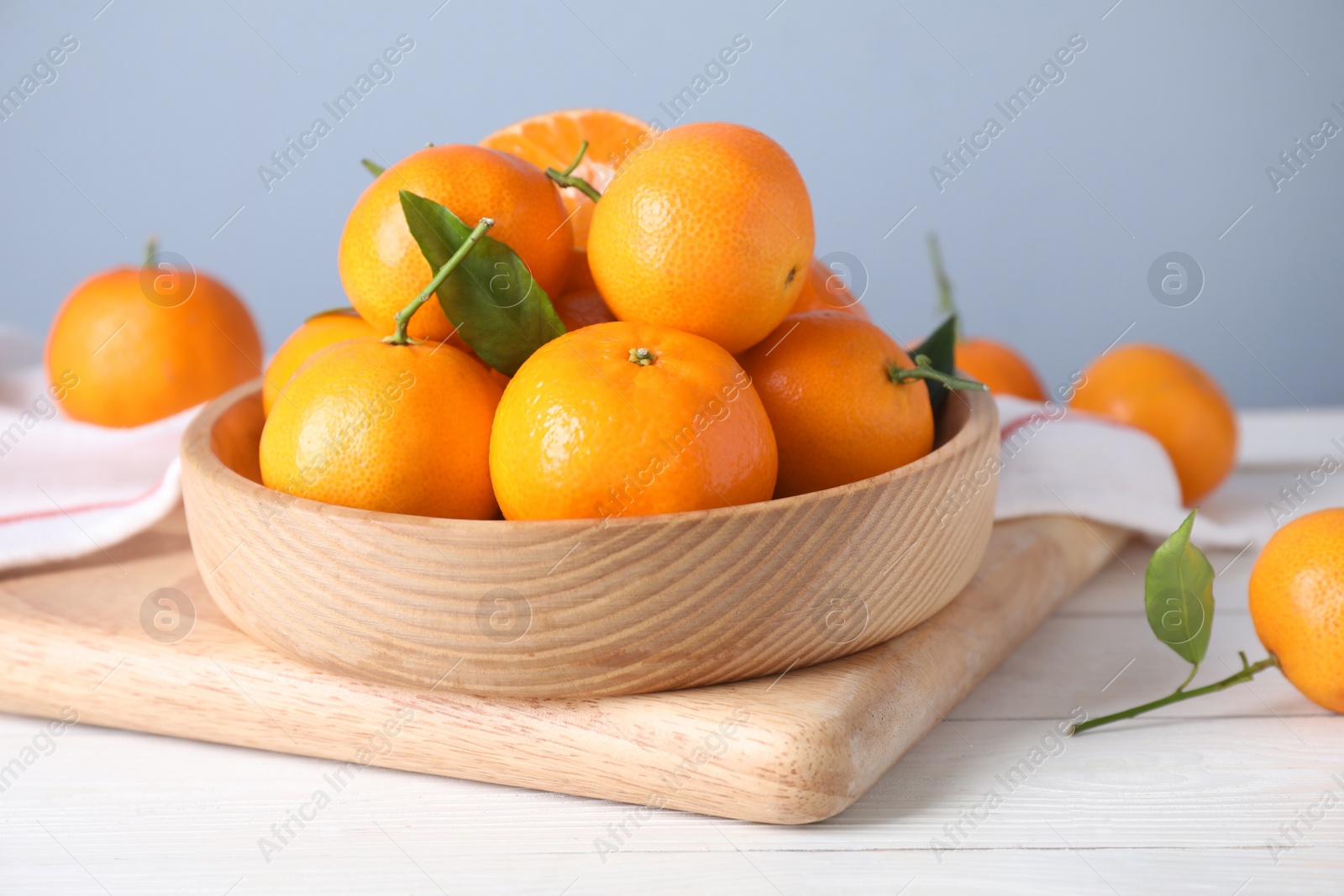 Photo of Fresh ripe tangerines on white wooden table