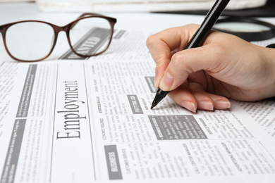 Photo of Woman marking advertisement in newspaper, closeup. Job search concept
