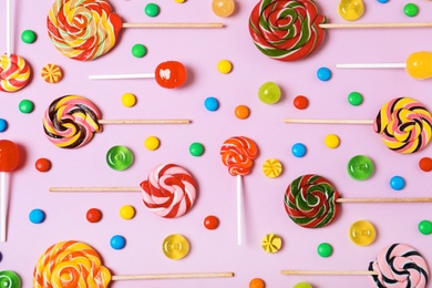 Photo of Flat lay composition with different candies on color background