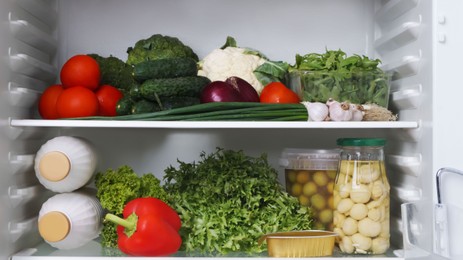 Photo of Many different healthy products on refrigerator shelves