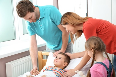 Happy family visiting little child in hospital