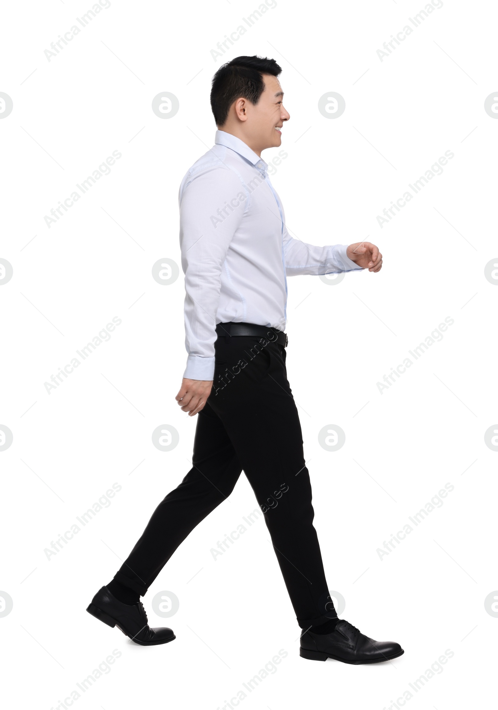 Photo of Businessman in formal clothes walking on white background