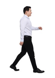 Photo of Businessman in formal clothes walking on white background